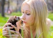 Girl Holding Black and White Rodent
