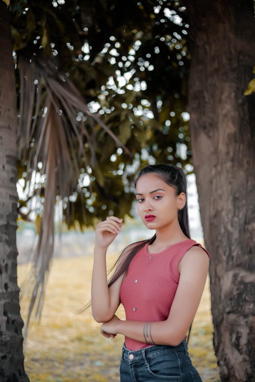 Selective Focus Photo of a Woman Posing Near Trees