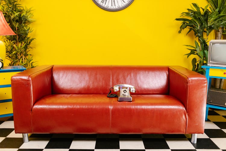 Rotary Phone On Red Couch
