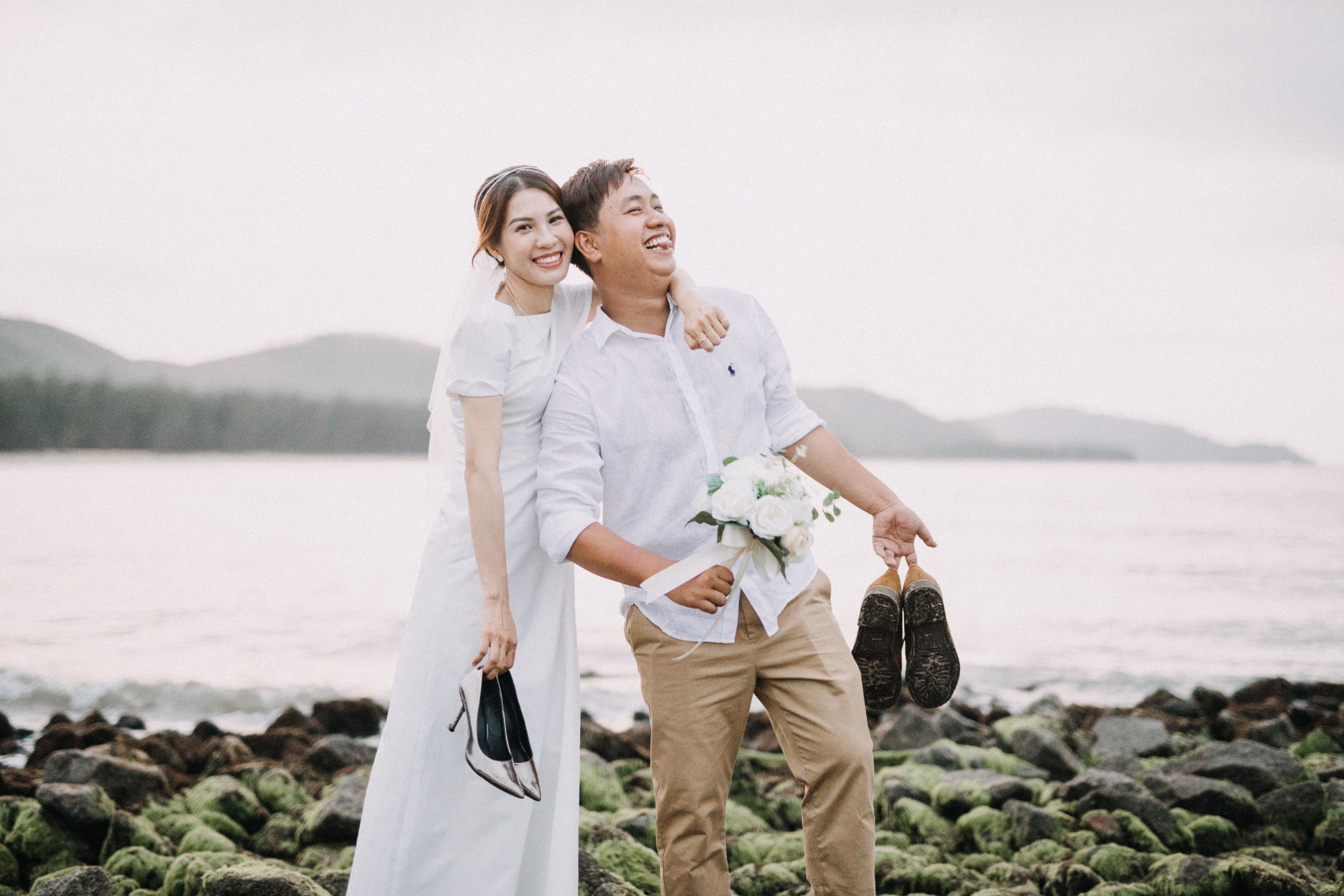 Happy couple celebrates their beach wedding in Hồ Chí Minh, Vietnam.