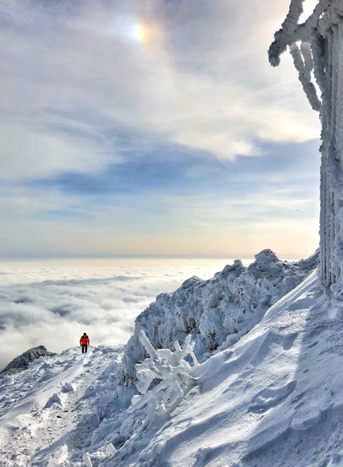 A Person Hiking in the Snowy Mountain