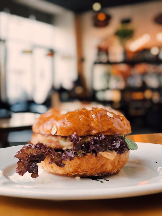 Selective Focus Photography of Burger on White Ceramic Plate