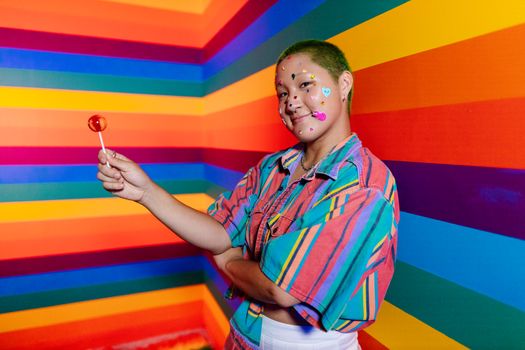 Boy in Blue and Orange Button Up Shirt Holding Lollipop