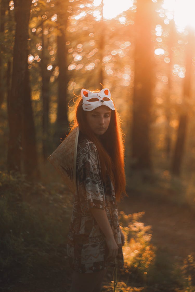 A Woman With A Mask In A Forest