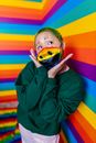 Boy in Green Sweater With Blue Mask