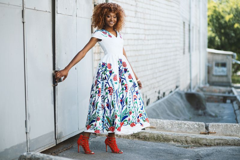 Woman in a colorful floral dress in an urban setting