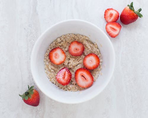 Free Strawberry on Table Top Near White Ceramic Bowl Stock Photo