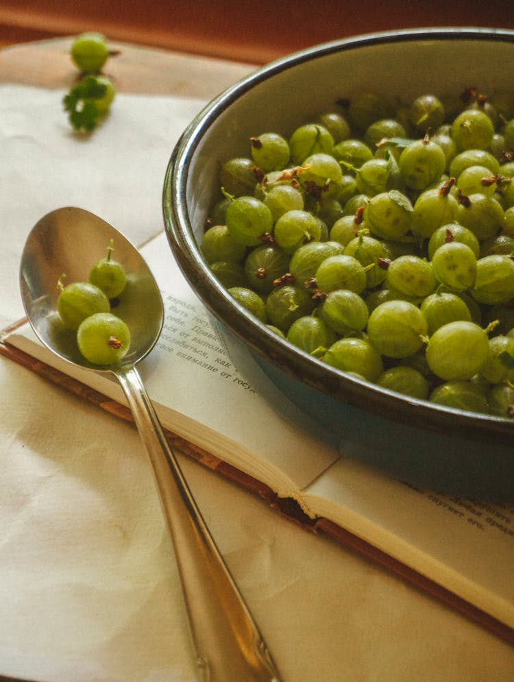 Green Gooseberry Fruits In A Bowl And Spoon