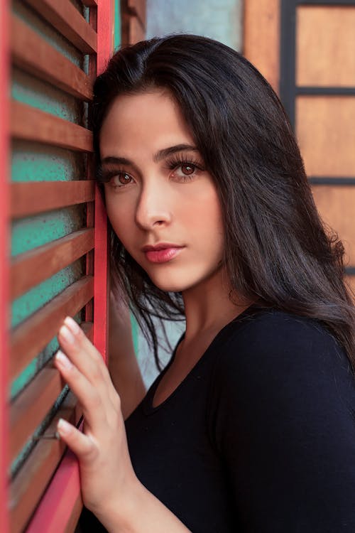 Young Brunette Woman Standing Against the Wall 