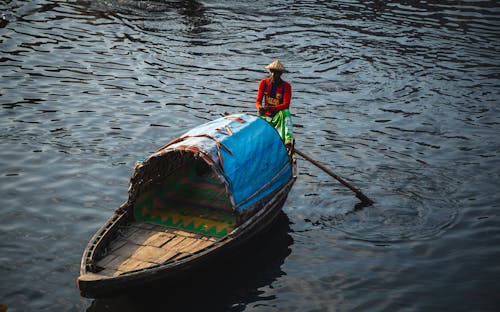 Person Riding a Wooden Boat