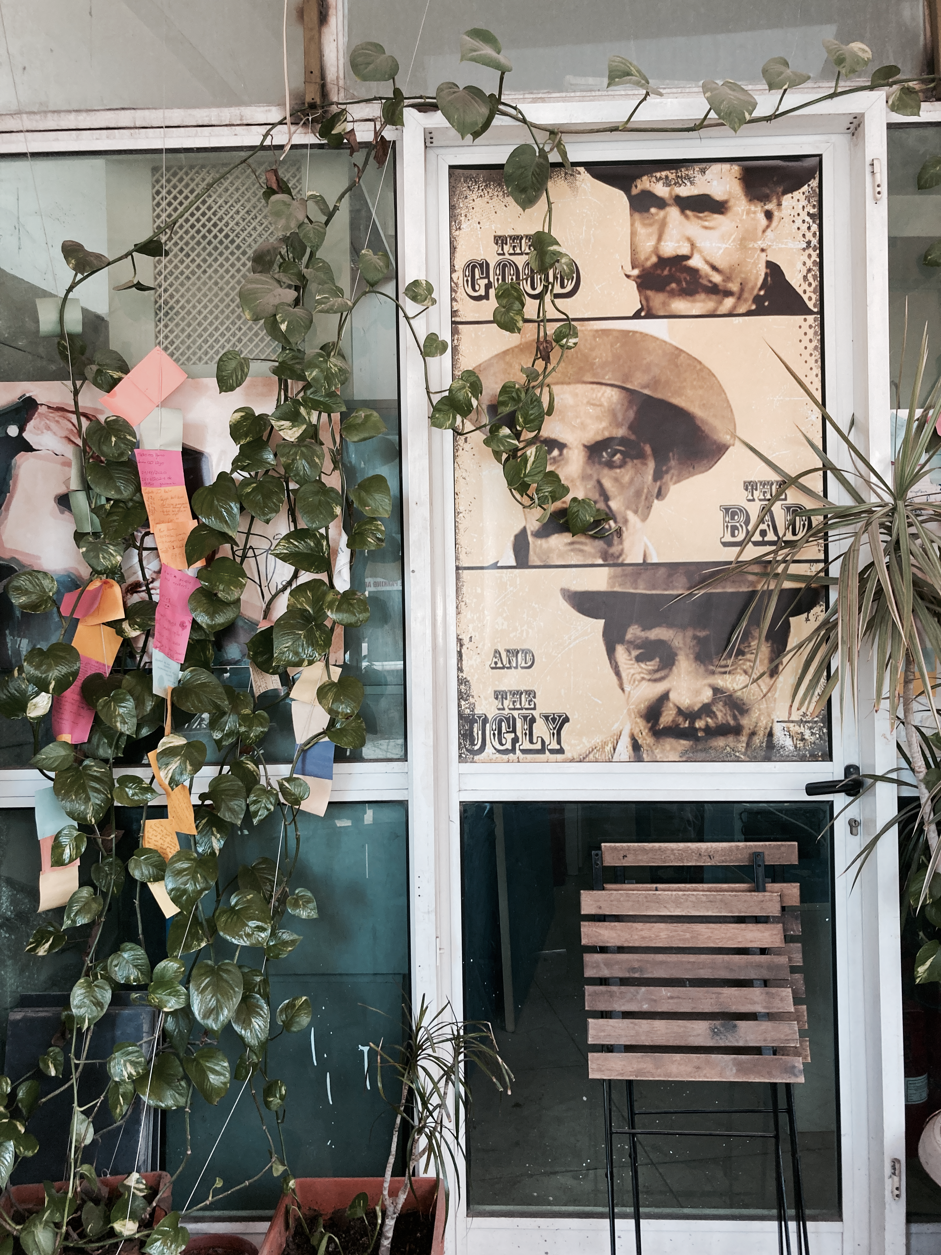 Retro themed doorway adorned with vines and vintage movie posters, exuding an old-school charm.