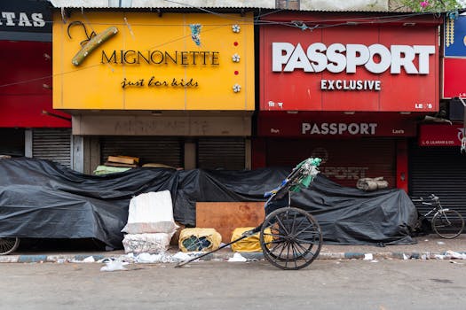 Urban scene with a rickshaw and storefronts, showcasing city life.