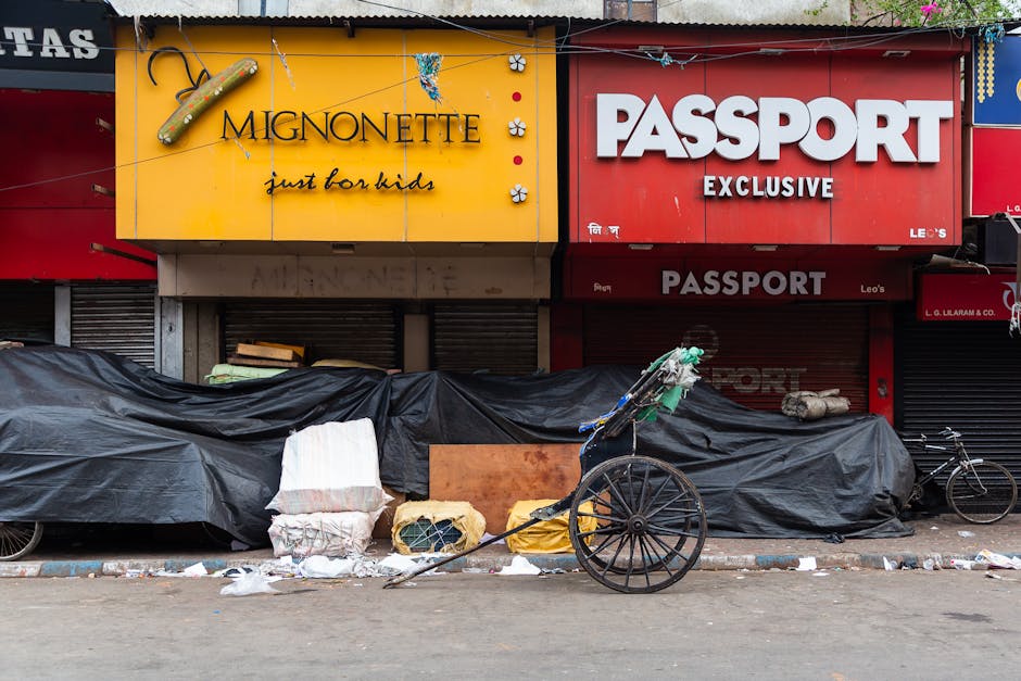 Urban scene with a rickshaw and storefronts, showcasing city life.