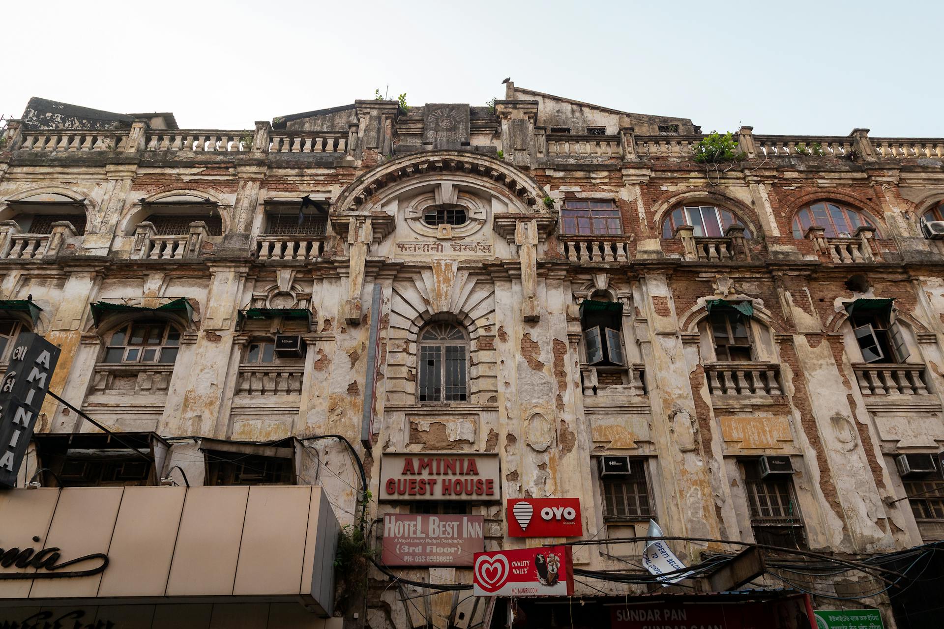 Detailed view of an old urban building facade with signs for a guest house and hotel. Rich in detail and texture.