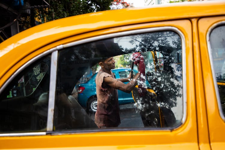 A Man Cleaning A Car