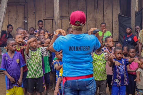 A Volunteer Giving Charity to Children