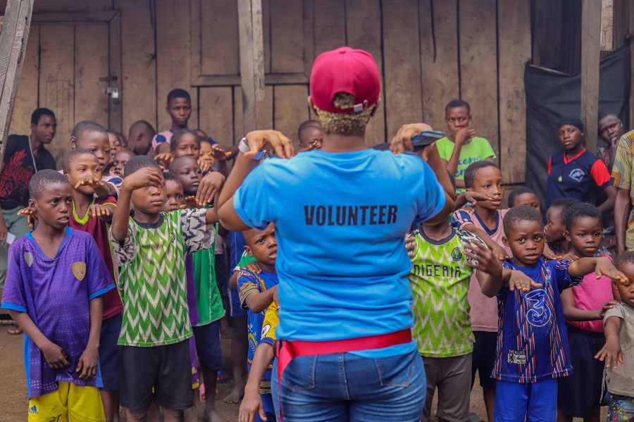 Volunteer engaging children in a community activity