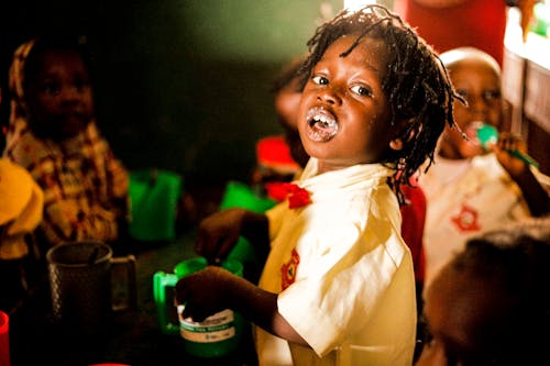 Free Boy in White Shirt Holding Green Plastic Cup Stock Photo