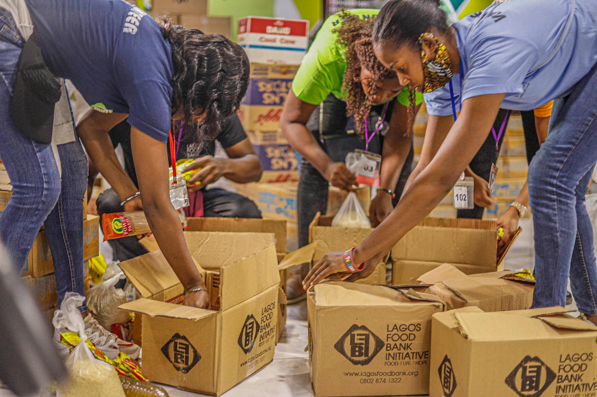 Team of volunteers sorting and packing food donations for a local charity initiative.