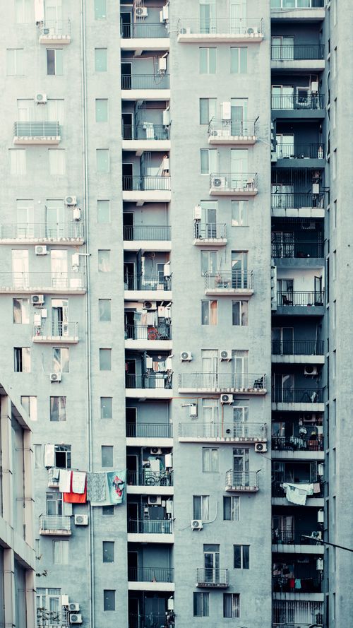 Free Tall residential building with balconies in Georgia showcasing urban architecture. Stock Photo