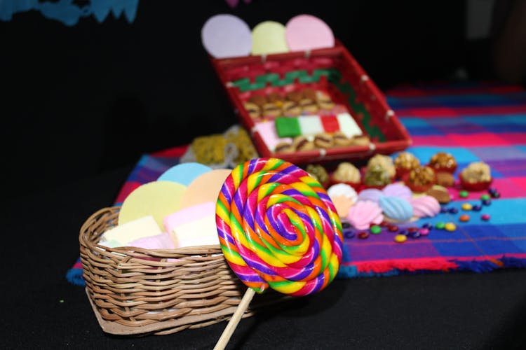 Close Up Photo Of Lolipop Beside Woven Basket