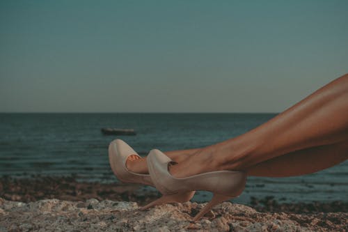 Free 

A Woman Wearing Heels on a Shore Stock Photo