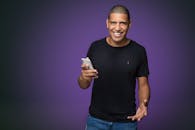 Man in Black Shirt Holding White Mobile Phone