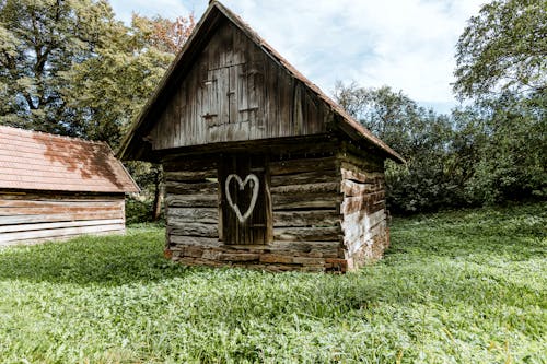 Brown Wooden House on Green Grass Field