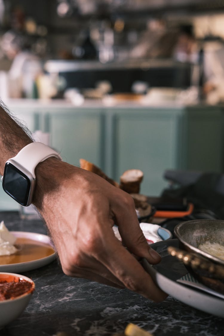 Close Up Of Hand And Cookware