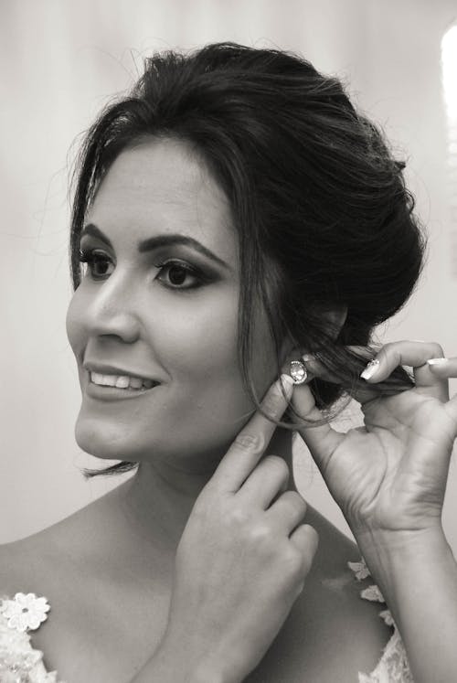 Grayscale Photo of a Woman Wearing Earrings