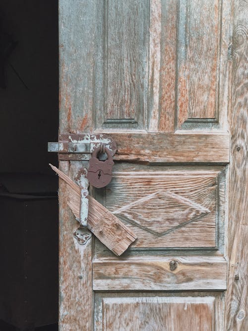 A Wooden Door With Padlock