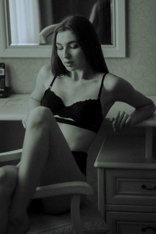 Woman in Black Brassiere and Panty Sitting on Wooden Chair
