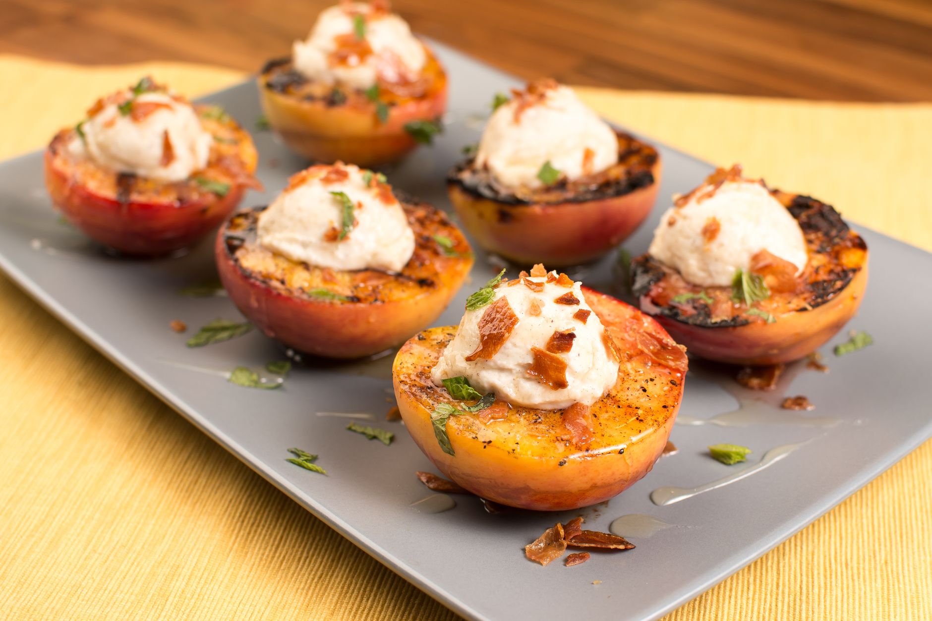 Grilled peach wedges soaking in red wine glass