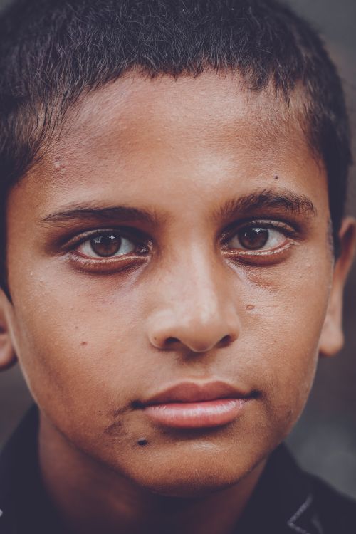 Free Intimate close-up portrait of a young boy expressing deep thought and emotion. Stock Photo