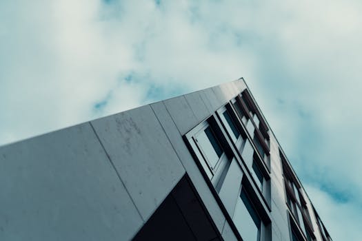 Low angle view of a modern building against a cloudy sky in Wiesbaden, Germany, showcasing urban architecture.
