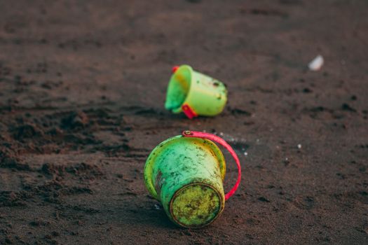 Two Green Pails on Ground