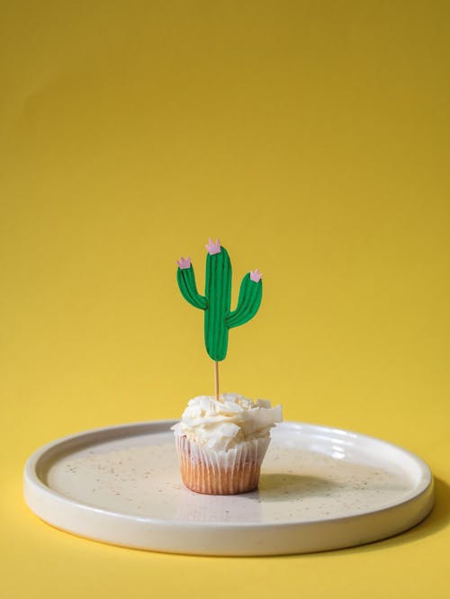 Free A Cupcake with Paper Cactus on a Plate Stock Photo
