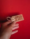 Person Holding White and Brown Tag