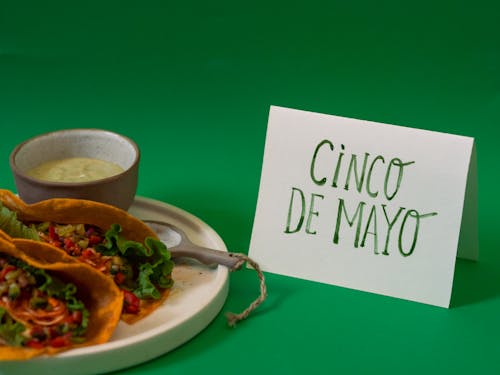 Free Tacos on White Ceramic Plate on Green Background Stock Photo