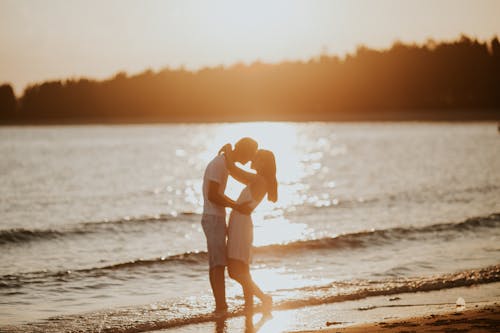 Silhouette of a Couple Kissing During Sunset