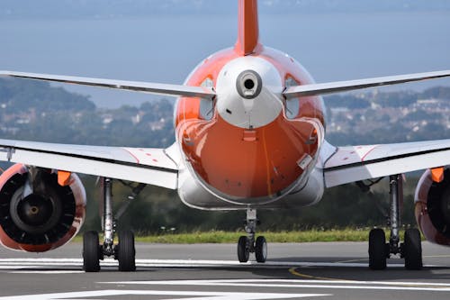 Orange and White Airplane on Airport