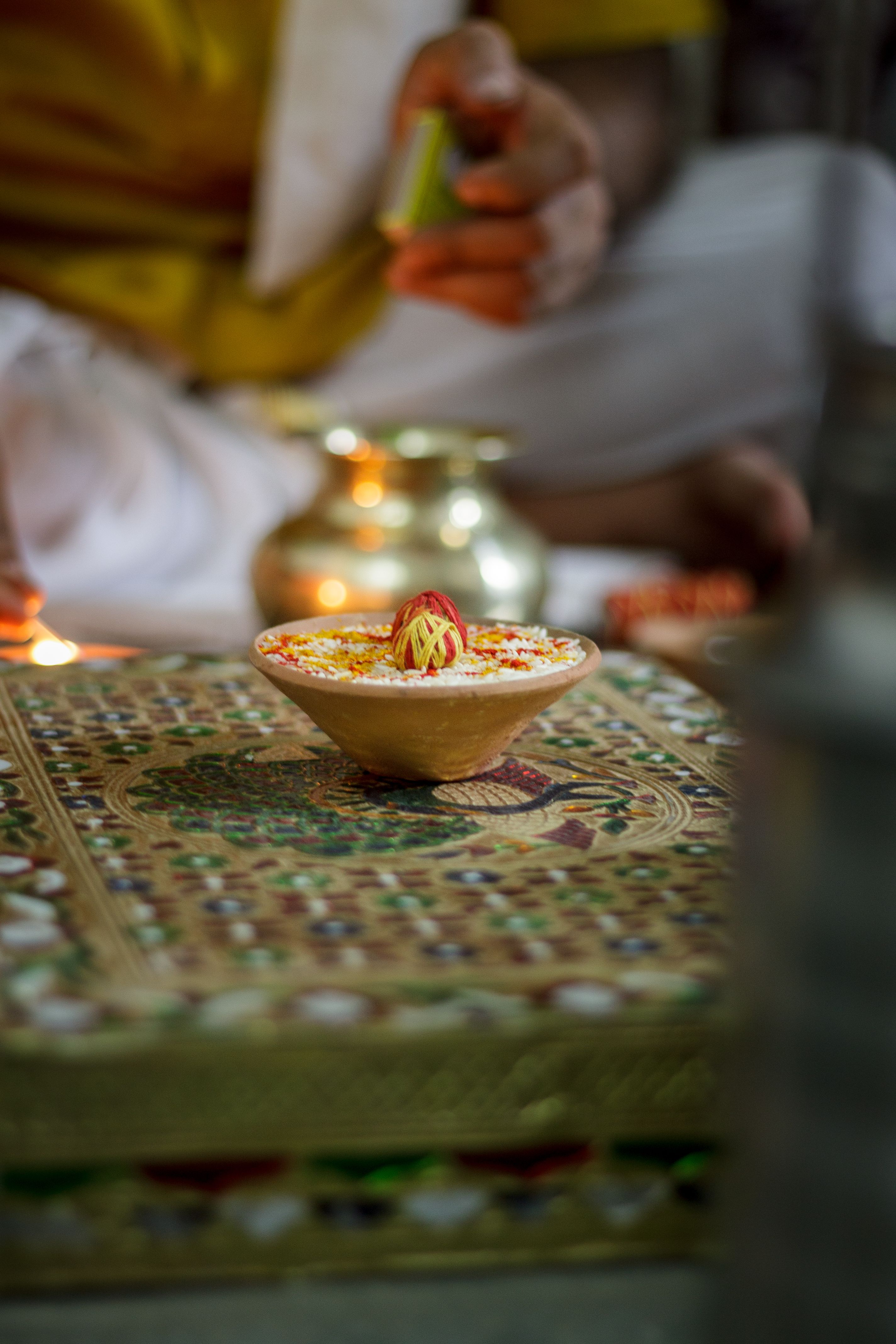 A colorful decorative bowl on a patterned tablecloth, perfect for a spiritual setting.
