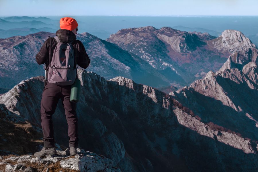 A hiker with a backpack taking in a mountain panorama — Zakhar Vozhdaienko on Pexels
