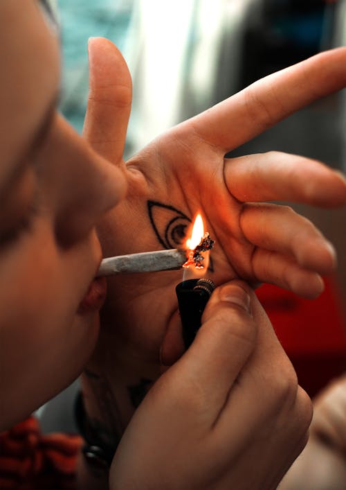 Free Person Lighting a Cigarette Stick Stock Photo