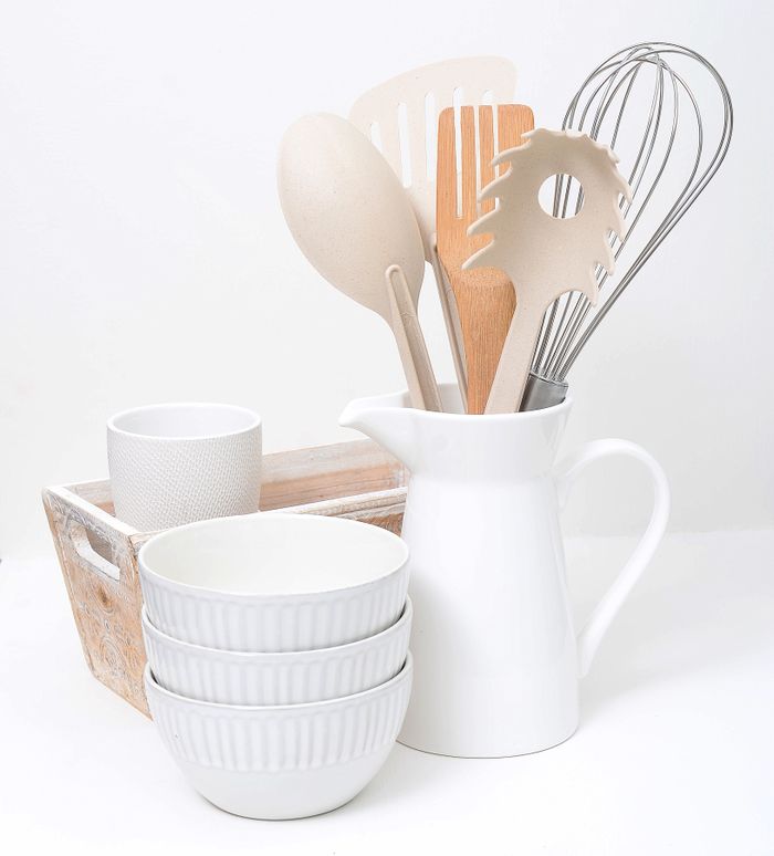 Simple white kitchenware with wooden serving utensils. Photo by DRAKE NICOLLS on Pexels