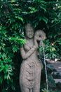 Gray Concrete Statue Near Green Plants