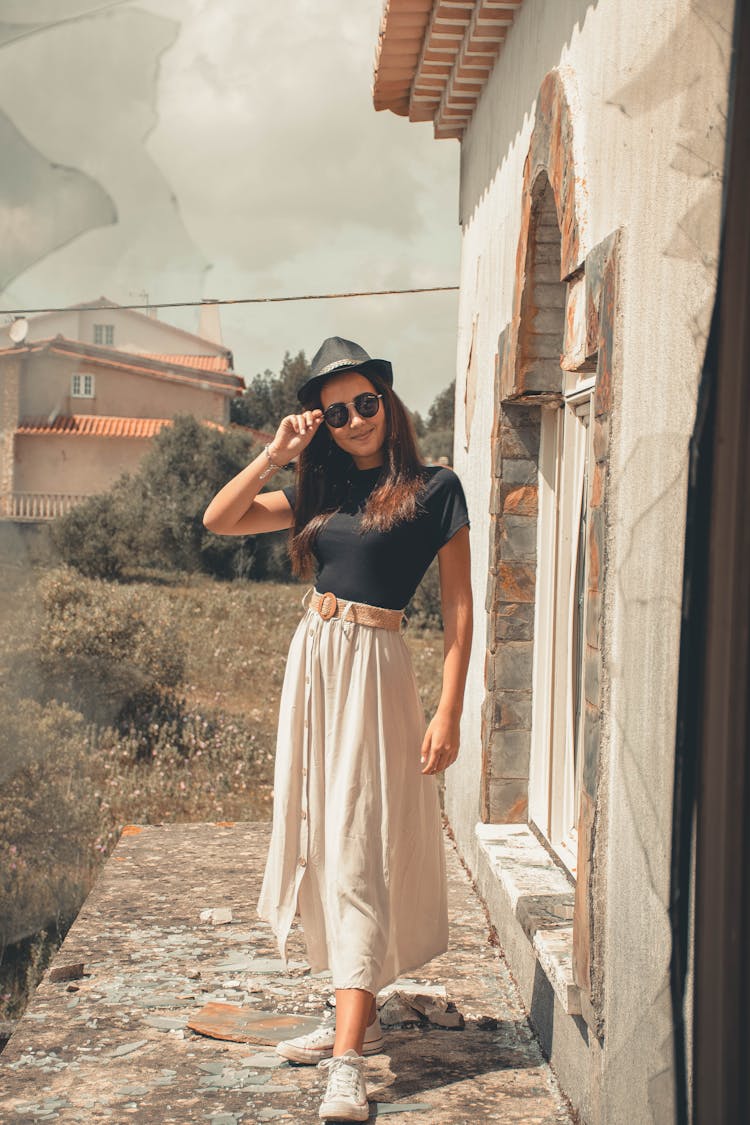 Woman In Black Top And Long Skirt Standing 