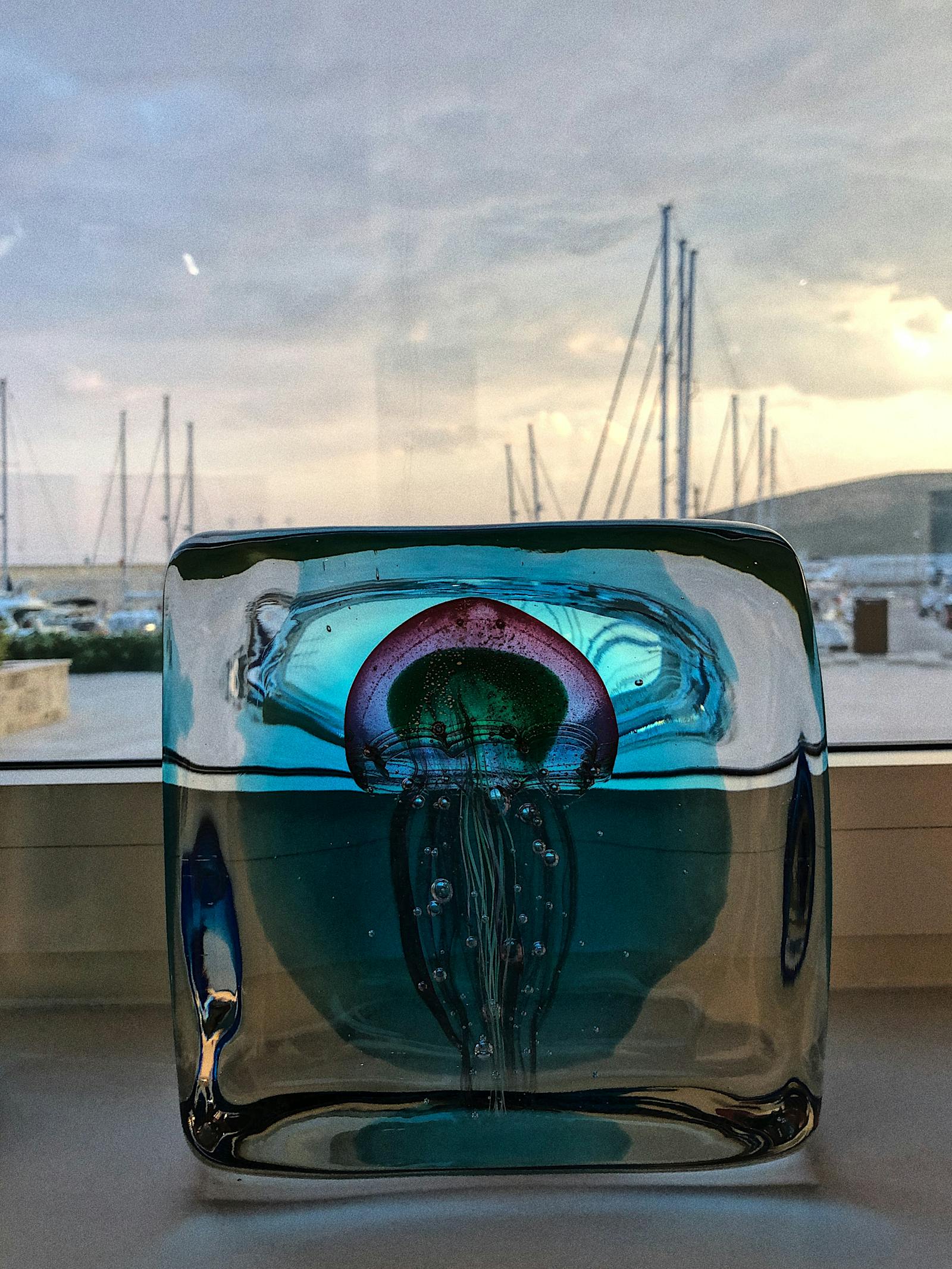 Mother sitting alone at a table looking at a drawing from her child