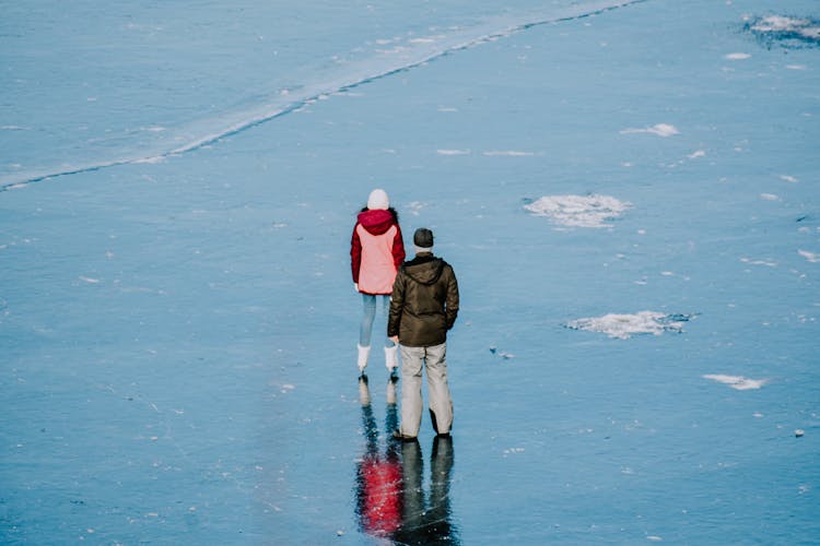 Back View Of A Couple Wearing Winter Clothes