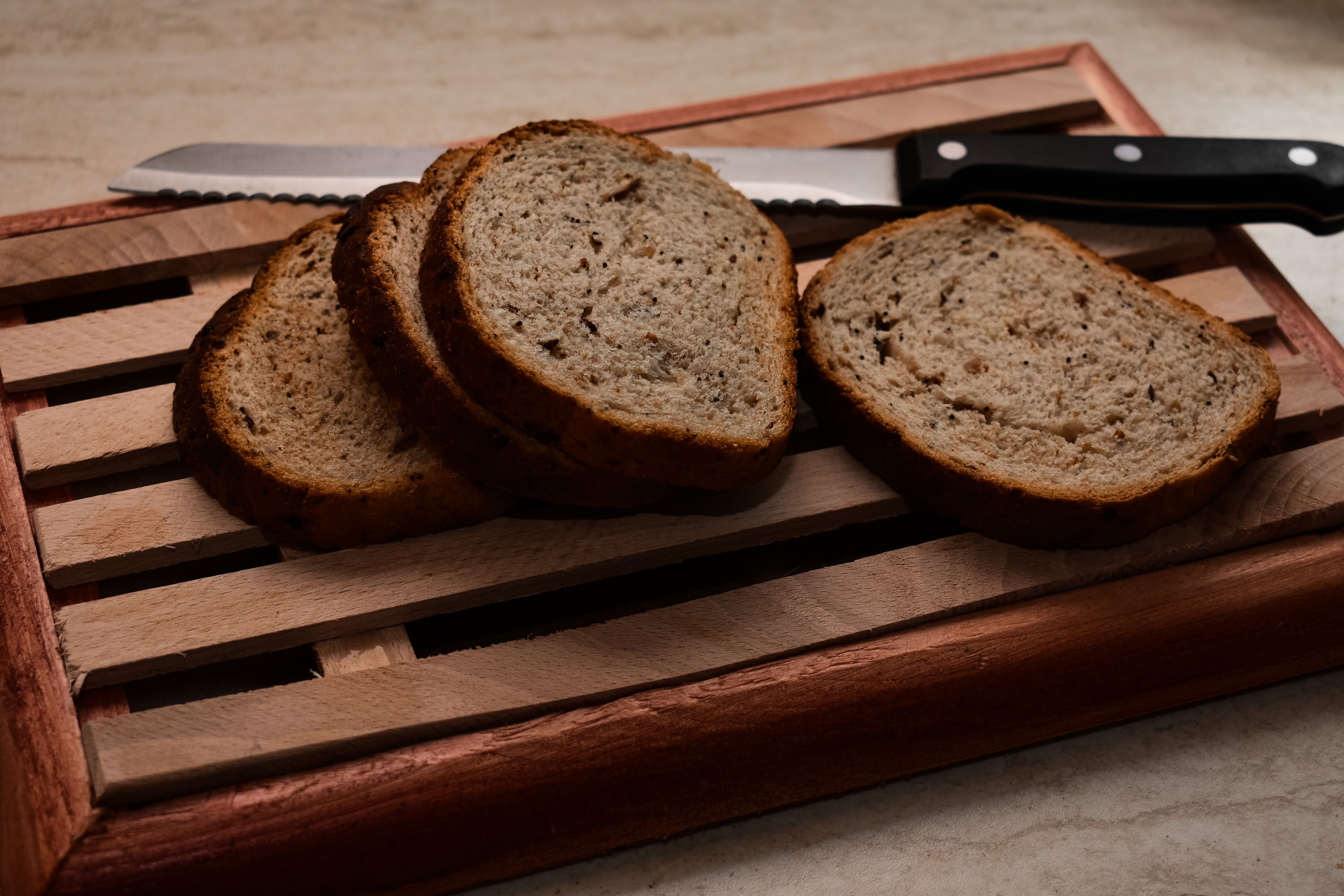 Freshly baked homemade bread sliced on a wooden cutting board